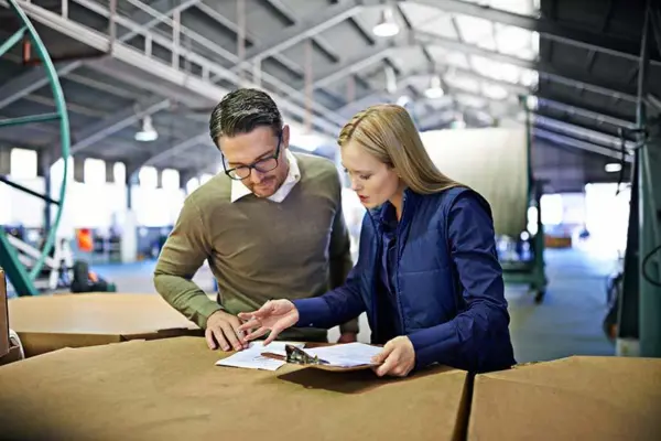 Warehouse managers reviewing inventory