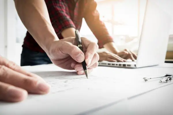 Manufacturing web design team with laptop